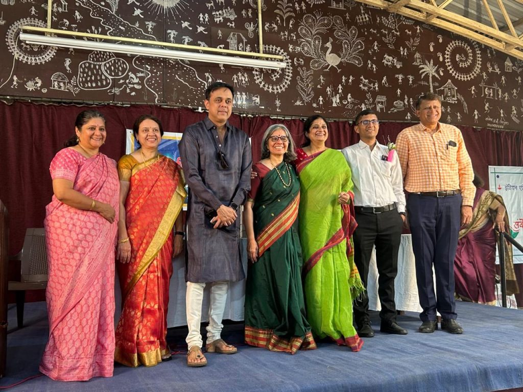 Seven people standing together for a photograph on stage